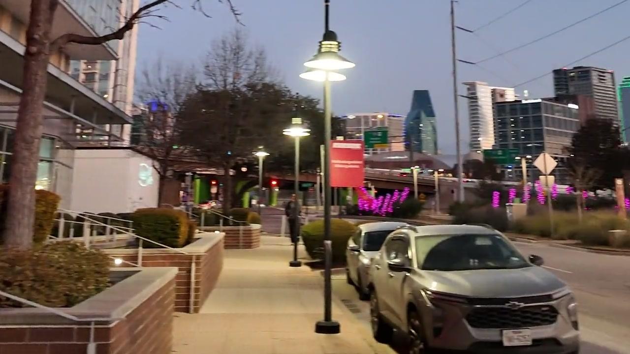 Hi Line Drive street view with Dallas skyline at evening