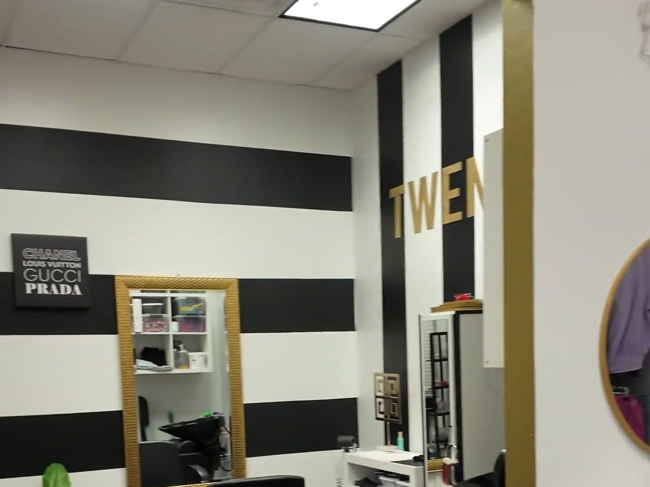 TWENTY suite with B&W stripes, gold accents, and Chanel-Gucci-Prada decor