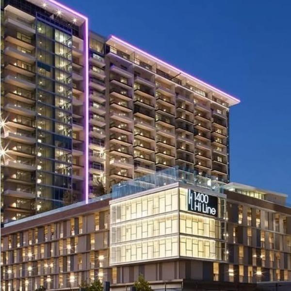 1400 Hi Line building exterior at night with purple lighting