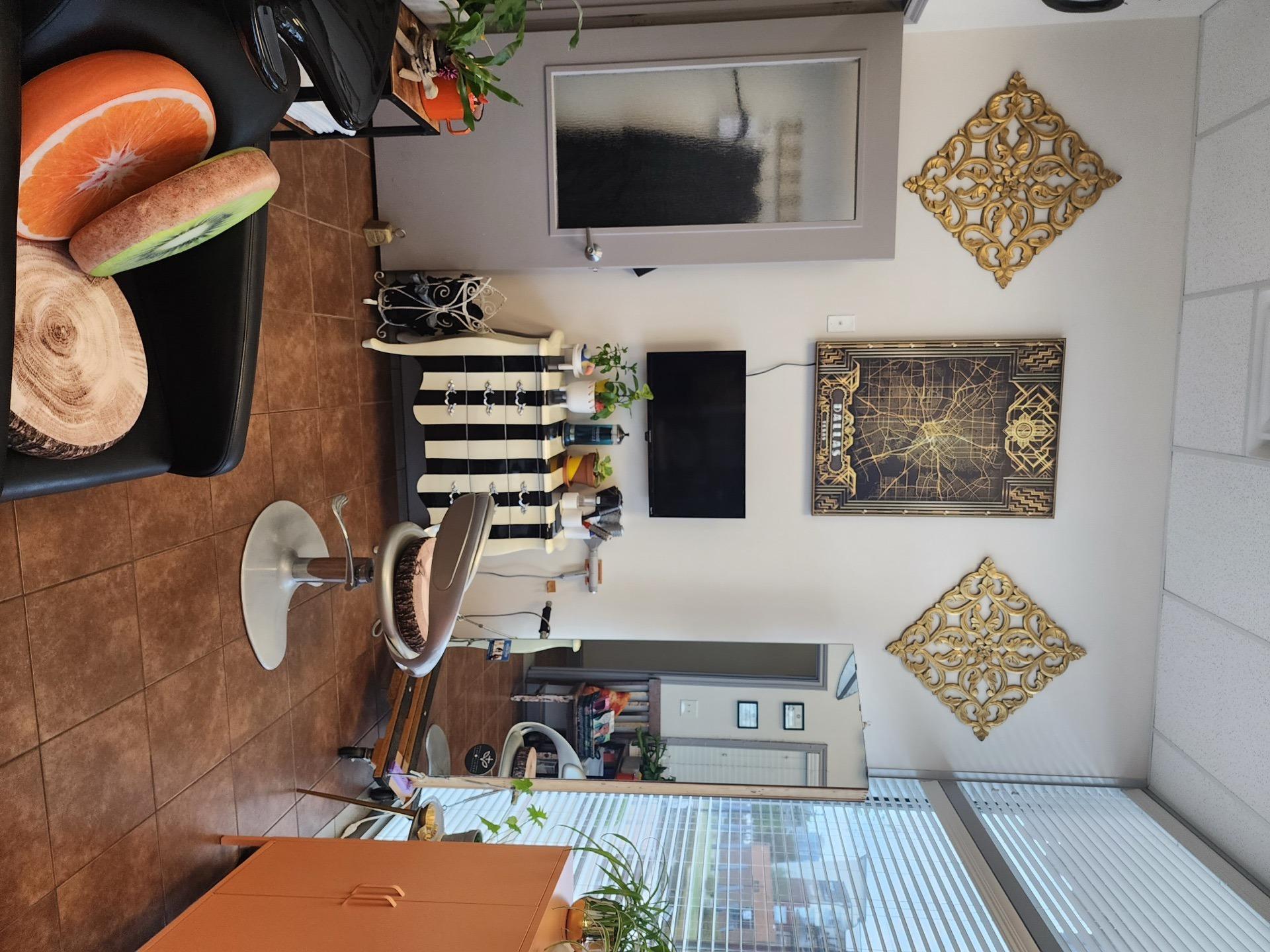 Salon suite with gold wall decor and large windows