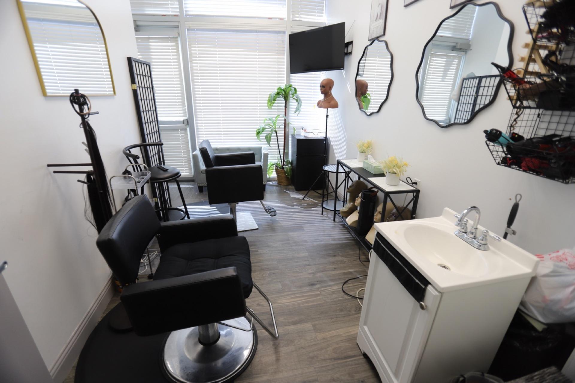 Bright salon suite with multiple mirrors and styling chair