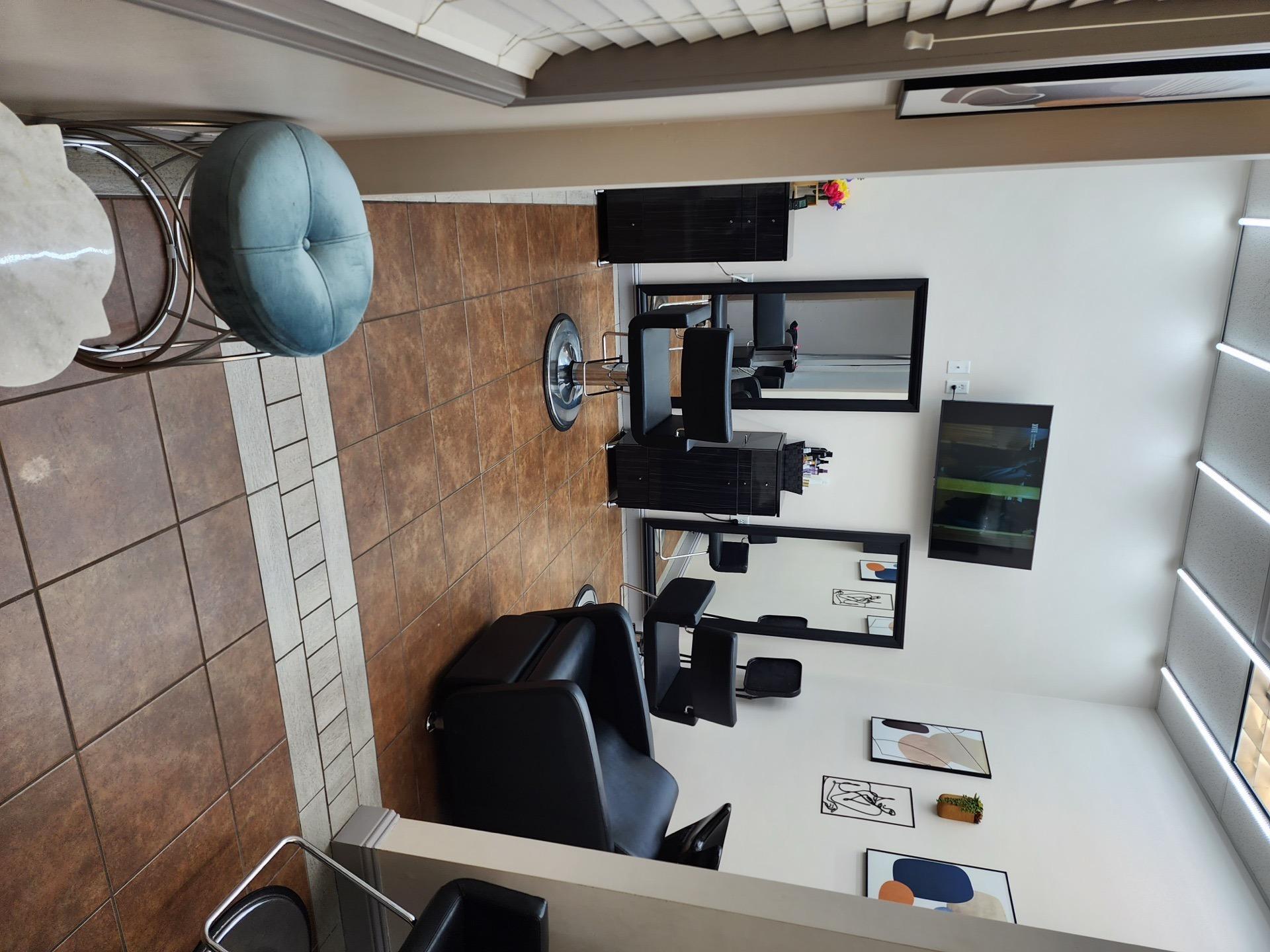 Modern salon suite with art wall and blue ottoman